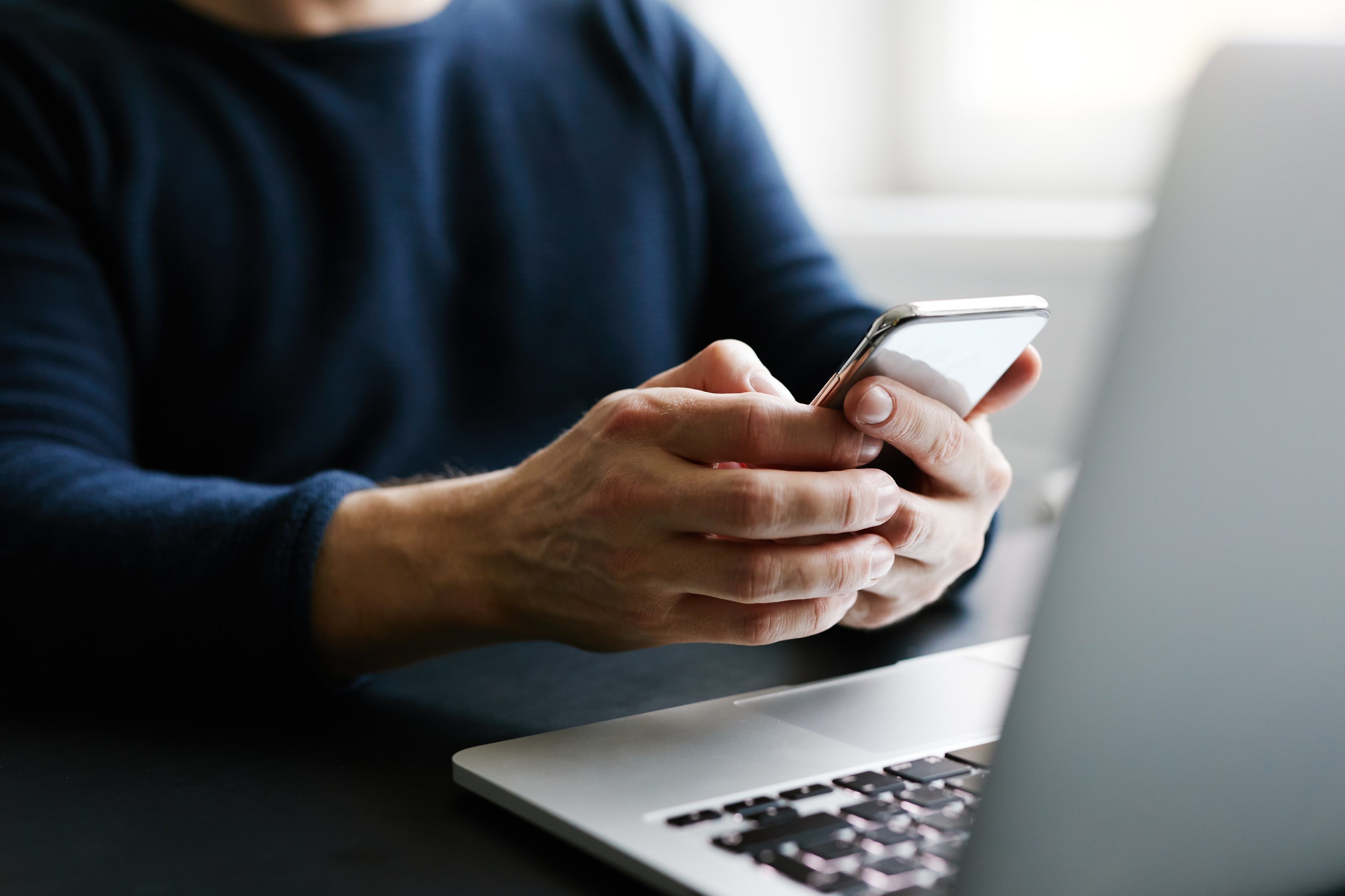 Man with Mobile Phone and Laptop